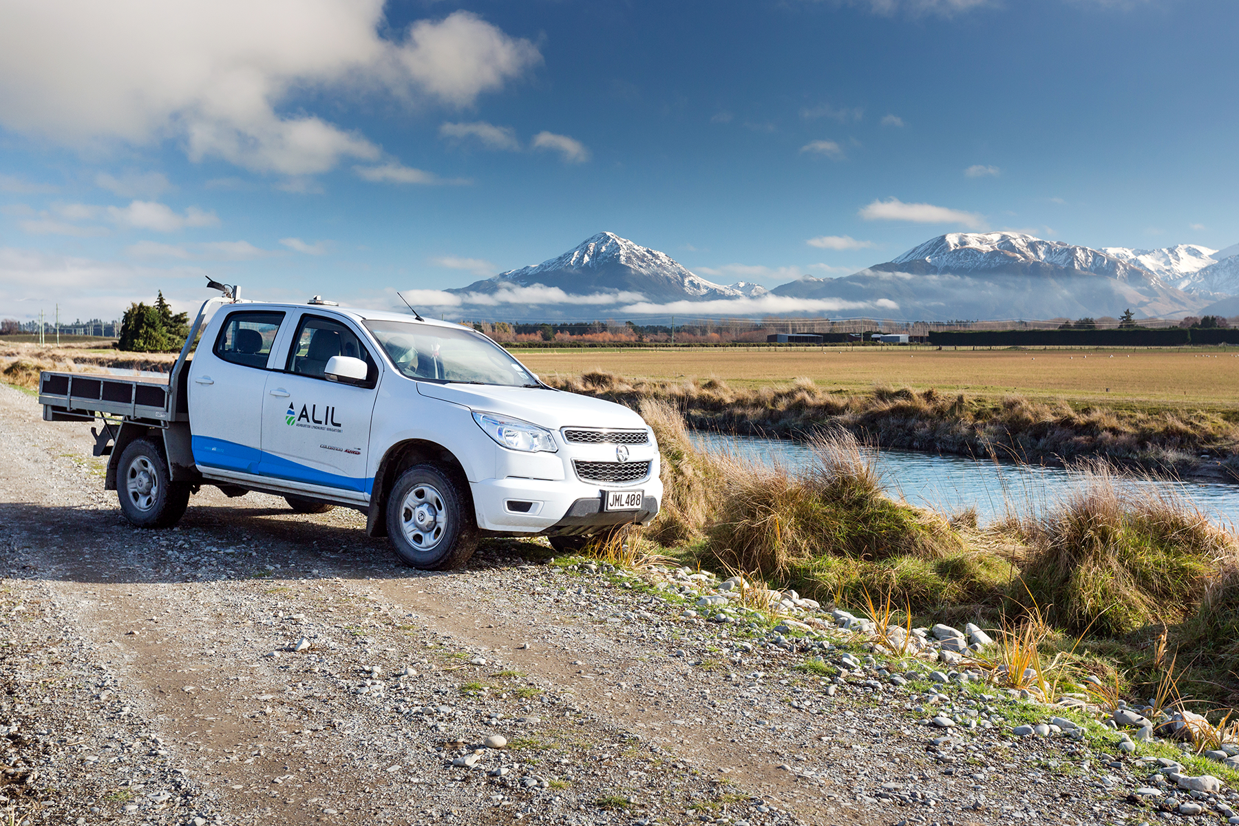 ALIL ute parked by a stream with mountains in the background - Ashburton Lyndhurst Irrigation Limited